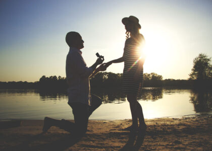 man proposing on lake side